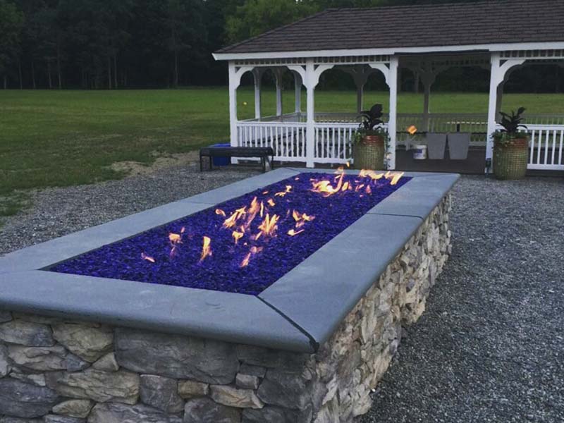 A lit fire pit outside at Bradford Recovery